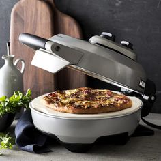 a pizza sitting on top of a white plate next to a cutting board and knife