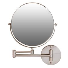 a round mirror mounted to the side of a metal wall mount bathroom sink faucet