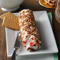 a piece of cake sitting on top of a white plate next to a cracker