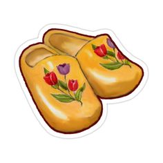 a pair of yellow slippers with flowers painted on them