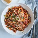 a white bowl filled with pasta and sauce