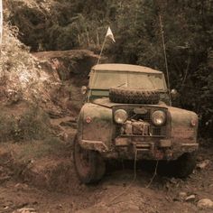 an old jeep is stuck in the mud