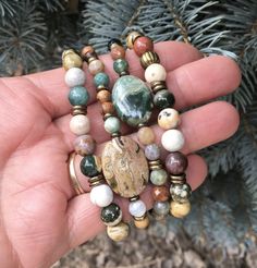 "I'm so happy to share these gorgeous Ocean Jasper stretch bracelets with you! I selected high quality 8mm round beads, and mixed them with rustic brass accent beads for a great look! You can easily mix these bracelets with your other favorites, or purchase more than one for a stacked look (as shown in the photos). You will receive one bracelet. Shown in size 7\", they also come is sizes 6\", 6.5\", 7.5\" and 8\". All are different, but equally beautiful. This multicolored natural stone from Mad Rustic Beaded Bracelets With Natural Stones, Bohemian Jasper Round Bead Bracelets, Earthy Jasper Beaded Bracelets, Rustic Multicolor Round Bead Bracelets, Fall Bracelets, Stretch Beaded Bracelets, Ocean Jasper Jewelry, Random Jewelry, Autumn Bracelet