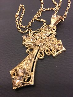 24k antique gold plated cross with champagne colored crystals. Picture does not do justice. I always get compliments when I'm wearing this out. Luxury Yellow Gold Crucifix Jewelry, Arte Bob Marley, Golden Arrow, Dope Jewelry Accessories, Pretty Jewelry Necklaces, Jewelry Accessories Ideas, Gold Cross Pendant, Dope Jewelry, Jewelry Fashion Trends