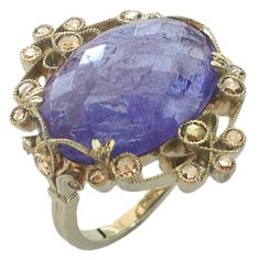 Dalben Tanzanite Diamond Gold Ring | From a unique collection of vintage cocktail rings at https://www.1stdibs.com/jewelry/rings/cocktail-rings/ Elegant Tanzanite Diamond Cut Ring, Luxury Tanzanite Ring With Diamond Cut, Formal Amethyst Ring With Rose Cut Diamonds, Elegant Amethyst Ring With Rose Cut Diamonds, Elegant Round Rose Cut Diamonds, Fine Jewelry Tanzanite Rings With Diamond Cut, Oval Faceted Sapphire Ring Fine Jewelry, Luxury Yellow Gold Amethyst Ring With Rose Cut Diamonds, Formal Rose Cut Amethyst Ring In Yellow Gold