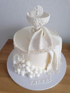 a cake with white frosting and lace on it