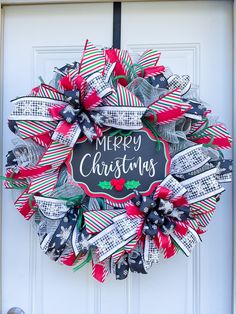 a christmas wreath with the words merry christmas written on it in black and red colors