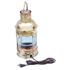 an old brass lantern with a cord attached to it on a white background, the light is turned off