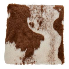 a brown and white animal print pillow on a white background