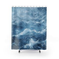 a shower curtain with blue and white waves in the ocean on it's sides