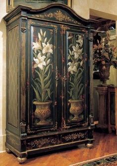 an ornate armoire with flowers painted on it