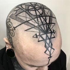 a man with a black and white tattoo on his head