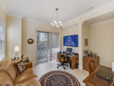 a living room filled with furniture and a flat screen tv mounted to the side of a wall