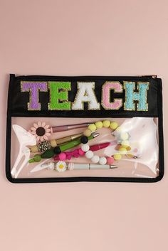 a black pencil case filled with lots of different colored pens