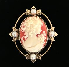 Cameo brooch. Lovely detailed resin cameo in an antiqued goldplated setting. Accented with cream color faux pearls. The pinback has also a bail so it can also be worn as a pendant. 2 1/2 inches longa beautiful statement piece. The cameo is quite striking. It's a deep coral color background with a creamy white color woman. This unique dark coral color cameo brooch for women is a customer favorite. A gift box is included. Red Color Background, Hummingbird Gifts, Beautiful Anklet, Sterling Silver Anklet, Cameo Jewelry, Pearl Jewelry Sets, Victorian Lady, Palm Beach Gardens, Beach Gardens