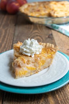 a slice of pie with whipped cream on top sits on a blue and white plate