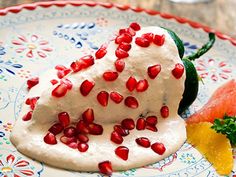 a plate that has some kind of food on it with pomegranates