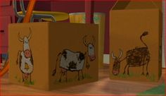 two cardboard boxes with drawings of cows on them