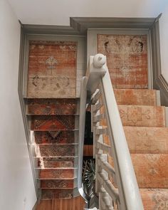 a staircase with carpeted steps leading up to the second floor