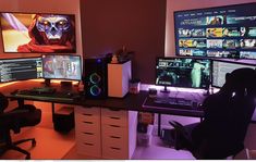 three computer monitors sitting next to each other on top of a desk in an office