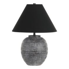 a lamp with a black shade on it and a white base in front of a white background