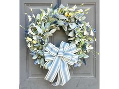 a blue and white wreath on a door