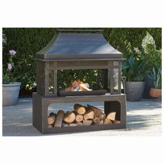 an outdoor fire pit with logs in it