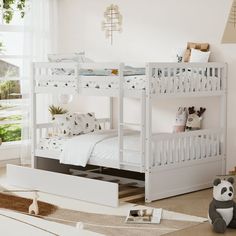 a white bunk bed sitting in a bedroom next to a teddy bear and other toys