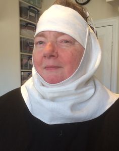 an older woman with a blindfold on her head