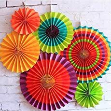 colorful paper fans hanging on the wall with text overlay that reads party decoration ideas