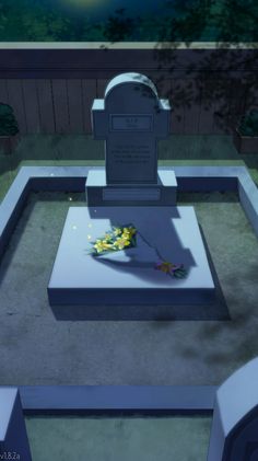 a grave with flowers on it in the middle of a yard at night time, next to a fence