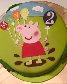 a peppa pig birthday cake with balloons and numbers