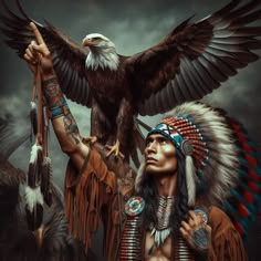 a native american man holding an eagle on his arm