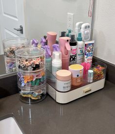 the bathroom counter has many items on it