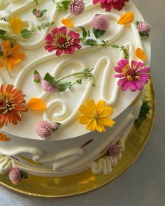 a cake decorated with flowers on a gold plate