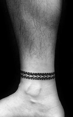 a black and white photo of a person's foot with a tattoo on it