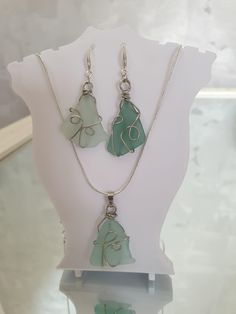 Embrace the calming hues of the Baltic Sea with this one-of-a-kind seaglass jewelry set! This handmade set includes a pair of earrings and a matching pendant, each featuring naturally tumbled light blue seaglass pieces collected from the shores of the Baltic Sea this summer. The seaglass is wrapped in copper wire for a rustic, boho-chic look, and both the earrings and the pendant feature 925 sterling silver components. Earrings: Each earring is approximately 5 cm long (including hooks), with the Clear Sea Glass Jewelry For Gifts, Clear Sea Glass Jewelry Gift, Clear Sea Glass Jewelry For Gift, Turquoise Recycled Glass Jewelry For Jewelry Making, Turquoise Recycled Glass Jewelry For Crafting, Wire Wrapped Clear Glass Jewelry, Clear Wire Wrapped Glass Jewelry, Clear Glass Wire Wrapped Jewelry, Handmade Blue Jewelry With Sea Glass