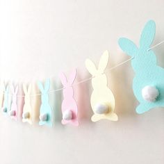 some paper bunnies are hanging on a clothes line