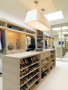 a walk in closet filled with lots of shoes