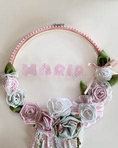 a pink and white flower wreath with the word mama spelled out