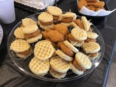 some chicken and waffles are sitting on a plate with toothpicks in them