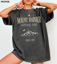 This Mount Rainier National Park comfort colors shirt is super soft and cozy. Perfect to lounge around, run errands, or walk your dog. ABOUT THIS SHIRT   ∙ Shirt is UNISEX and runs slightly large for ladies (For a relaxed fit, I suggest your usual size. For an oversized fit, I suggest sizing up 1 to 2 sizes.) ∙ 100% ring spun medium-weight cotton (soft-washed and garment-dyed) ∙ Colors may vary based on your monitor/screen display or lighting CARE INSTRUCTIONS ∙ Machine wash inside out in cold w Spring Outdoor T-shirt With Letter Print, Oversized Letter Print T-shirt For Outdoor, Fall Hiking T-shirt With Graphic Print, Casual Gray T-shirt For Outdoor, Oversized Letter Print Tops For Outdoor, Casual Relaxed Fit T-shirt For Outdoor Activities, Casual T-shirt For Outdoor Spring Activities, Casual T-shirt For Outdoor Spring Events, Casual T-shirt For Spring Outdoor Activities