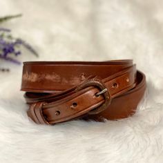 "Great condition! Vintage brown leather belt  Thick, quality full grain leather  Medium brown in color  Slightly polished finish  Silver toned hardware  The end with the holes has another piece of leather behind it Has some minor scuffs from normal wear but otherwise this is in excellent shape. Super sturdy!  1.5\" wide  34-39.5\" long" Boho Outdoor, Chunky Gold Chain, Boho Belts, Braided Leather Belt, Suede Tassel, Faux Leather Belts, Brown Leather Belt, Black Rhinestone, Leather Silver