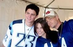 two men and a woman posing for a photo