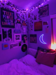 a bedroom with purple lights and pictures on the wall above it, along with various posters