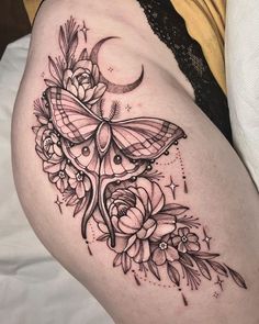 a woman's thigh with a butterfly and flowers on it