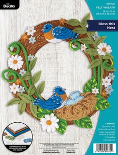 a paper craft kit featuring a wreath with birds and flowers