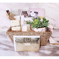 a wicker basket filled with assorted items on top of a marble countertop