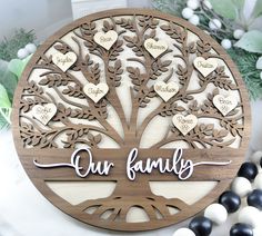 a wooden family tree with names and hearts on it, surrounded by other wood beads