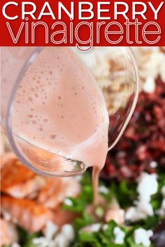 cranberry vinaigrete being poured into a glass with the ingredients in it